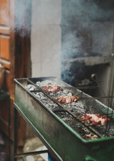 Sizzling chicken skewers cooked over hot charcoal